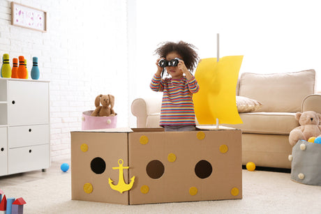 a little girl playing pretend in her living room